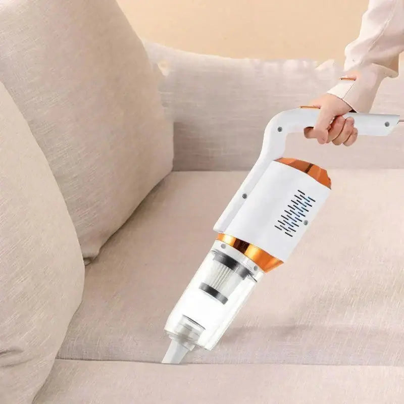 A person uses the white and orange 3-in-1 handheld vacuum to clean a sofa..Handheld vacuum cleaner being used on a beige sofa3-in-1 Wireless Vacuum Cleaner