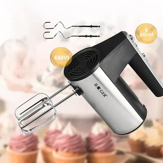 Hand mixer with attachments on a blurred background of cupcakes