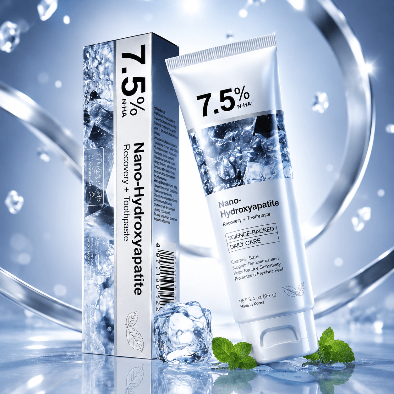A tube and box of Nano-Hydroxyapatite toothpaste and mouthwash, featuring a white and icy blue design with ice cubes and mint leaves on a reflective blue surface.