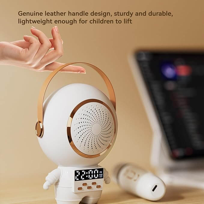 White robot toy with gold accents held by a hand, on a beige background. Astro Speaker
