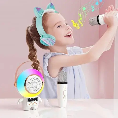 Child with colorful headphones and microphone, singing into a handheld microphone with a pink background Astro Speaker