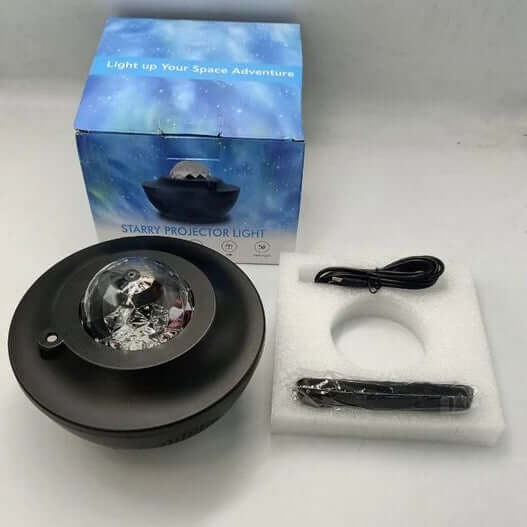 Starry projector light with packaging, cable, and remote control on a white surface