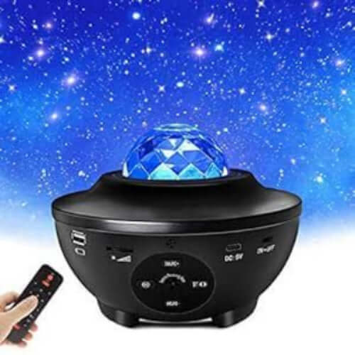 Black night light projector with remote control on a blue starry sky background
